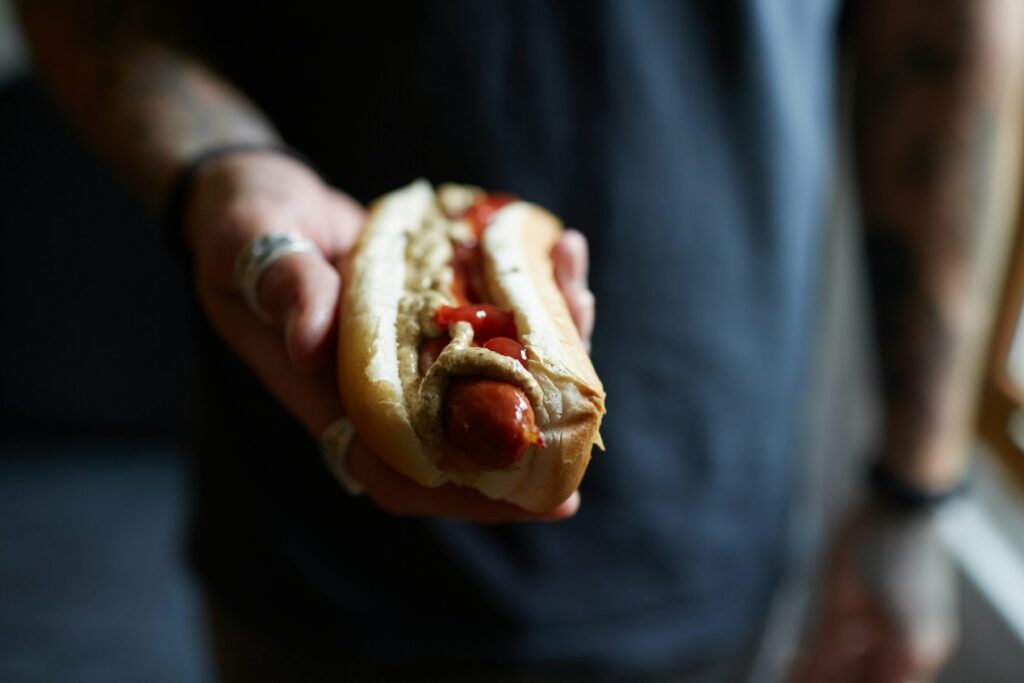 a person holding a hot dog. 