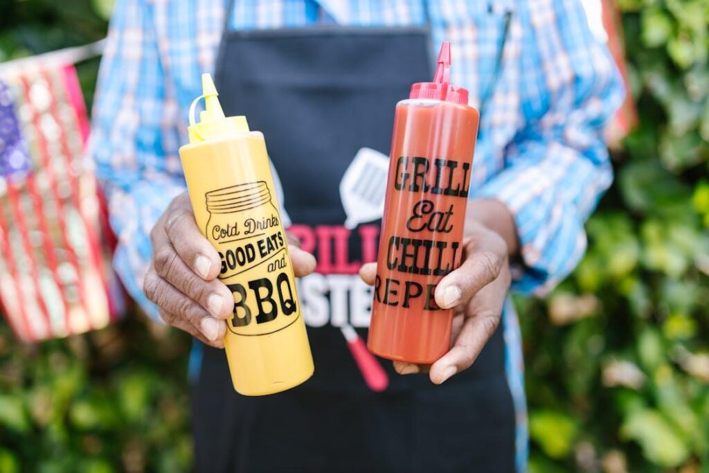 a man holding his local sauces, ketchup, and mustard in his hand
