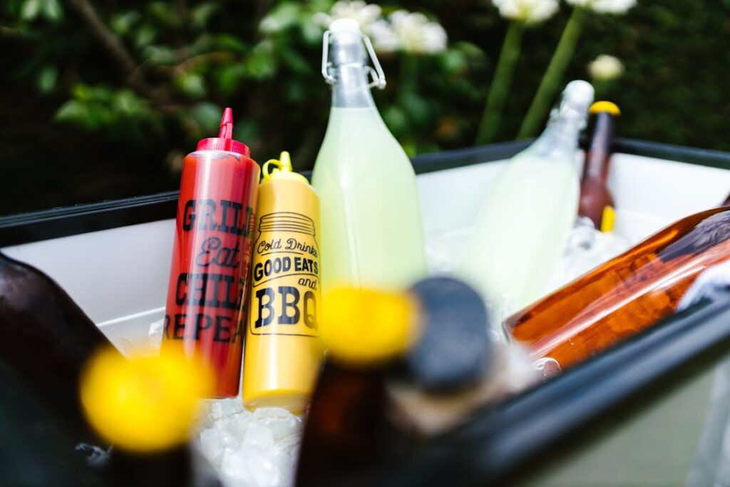 a shot of sauces placed in an ice bucket with drinks