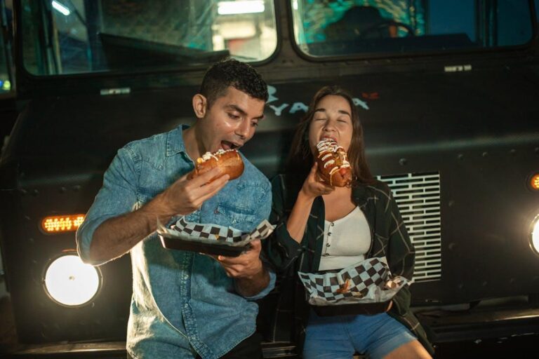 individuals enjoying loaded hot dogs