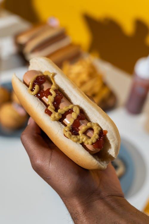 an aesthetic shot of a hotdog with ketchup and mustard