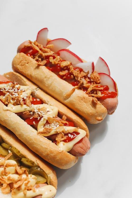 a close-up shot of hotdogs with different toppings