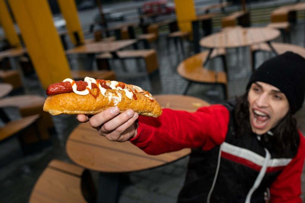 an individual holding a hotdog